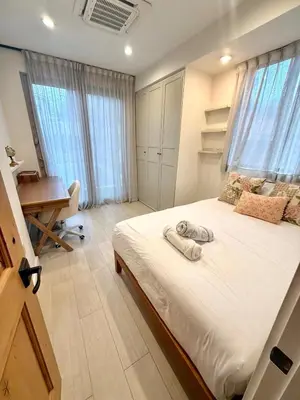 a bedroom with a bed with a desk and windows at Modern LA Villa 5BR Home with Private Pool & Yard in Los Angeles
