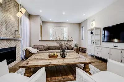 a living room with a table and a couch at Modern LA Villa 5BR Home with Private Pool & Yard in Los Angeles