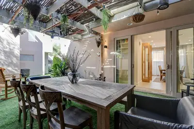 a dining room with a wooden table and chairs at Modern LA Villa 5BR Home with Private Pool & Yard in Los Angeles