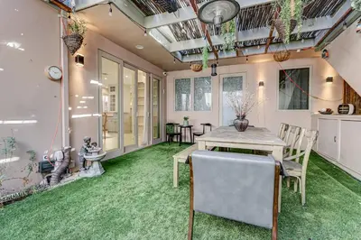 a dining room with a table and green carpet at Modern LA Villa 5BR Home with Private Pool & Yard in Los Angeles