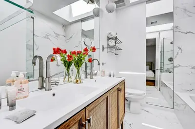 a bathroom with a sink with red flowers on it at Modern 4BR Villa Spacious Stylish In Prime Location in Los Angeles