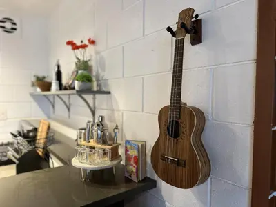 a guitar hanging on a wall in a kitchen at Ocean View Balcony, 4 Min Walk to Beach in Manhattan Beach