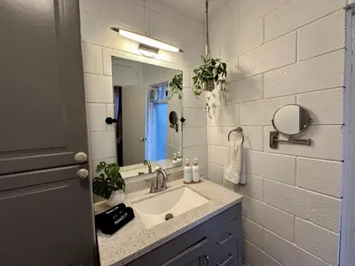 a bathroom with a sink and a mirror at Ocean View Balcony, 4 Min Walk to Beach in Manhattan Beach