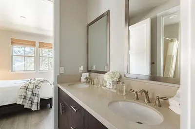 a bathroom with two sinks and a large mirror at The Reel Deal, Luxury Family Cabin by Alpine Slide in Big Bear Lake
