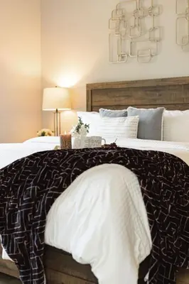 a bed with a brown and white blanket on it at The Reel Deal, Luxury Family Cabin by Alpine Slide in Big Bear Lake