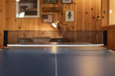 a ping pong net on top of a tennis court at Lakeside Lodge - Deck Views, Golf, Basketball, Spa in Fawnskin