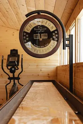 a clock on the wall of a wooden cabin at Lakeside Lodge - Deck Views, Golf, Basketball, Spa in Fawnskin