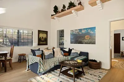 a living room with a couch and a table at Acorn Cottage in Big Bear Lake