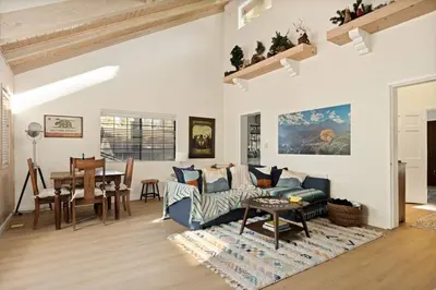 a living room with a couch and a table at Acorn Cottage in Big Bear Lake