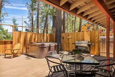 a patio with a grill and a table and chairs at Lawliss Hideout in Big Bear Lake in Big Bear Lake
