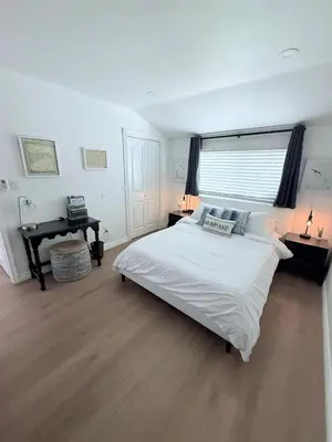 a white bedroom with a large bed and a desk at Private 1BR 1BA Suite, Kitchen, Fireplace, Parking in Simi Valley