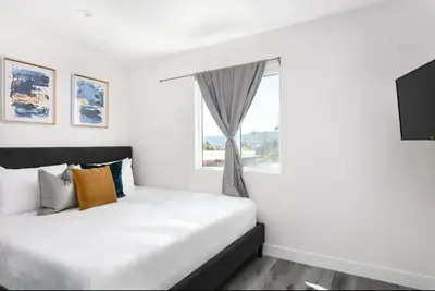 a bedroom with a white bed and a window at Luxury 3BR Condo Near Americana and Galleria in Glendale