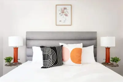 a bedroom with a white bed with pillows and two lamps at Luxury 3BR Condo Near Americana and Galleria in Glendale