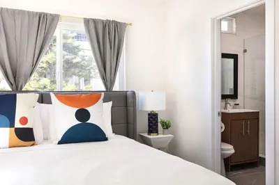 a bedroom with a bed with a person sitting on it at Relax in Spacious 3BR Apt Sleeps 8 and Parking in Glendale