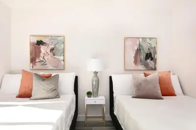 two beds sitting next to each other in a room at Relax in Spacious 3BR Apt Sleeps 8 and Parking in Glendale