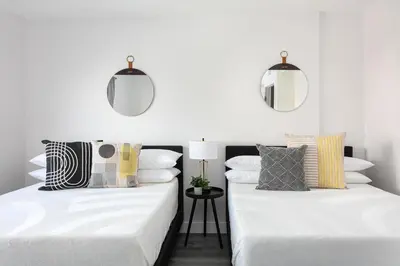 two beds in a room with white walls at Modern 3BR Apt with Parking in Glendale in Glendale
