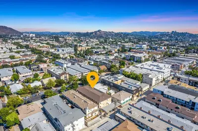 an overhead view of a city with buildings and a yellow arrow at Modern 3BR Apt with Parking in Glendale in Glendale