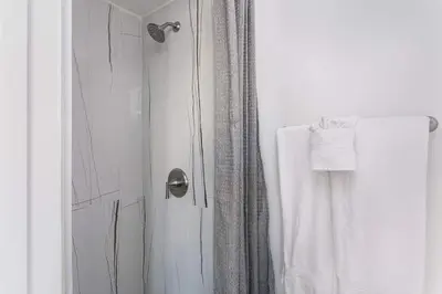 a bathroom with a shower with a shower curtain at Enjoy Stylish 3BR Apt Sleeps 6 with Free Parking in Glendale