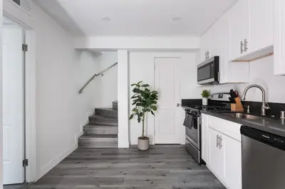 a kitchen with white cabinets and a potted plant at Enjoy Stylish 3BR Apt Sleeps 6 with Free Parking in Glendale