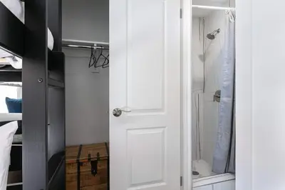 a bathroom with a white door and a shower at Enjoy Stylish 3BR Apt Sleeps 6 with Free Parking in Glendale