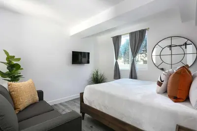 a bedroom with a large bed and a couch at Enjoy Stylish 3BR Apt Sleeps 6 with Free Parking in Glendale