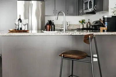 a kitchen with a counter with a bar stool at Luxury Spacious Studio in Los Angeles