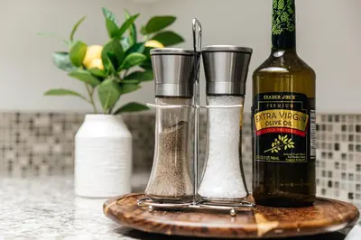 a counter with a bottle of spices and a bottle of wine at Luxury Spacious Studio in Los Angeles