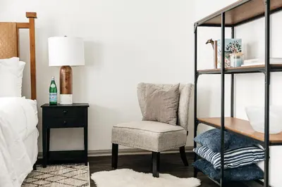 a bedroom with a chair and a table at Luxury Spacious Studio in Los Angeles