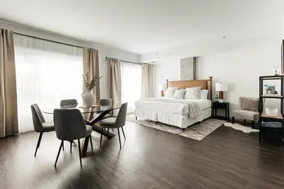 a bedroom with a bed and a table and chairs at Luxury Spacious Studio in Los Angeles