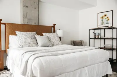 a bedroom with a large bed with white sheets and pillows at Luxury Spacious Studio in Los Angeles