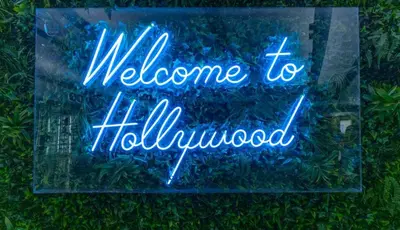 a neon sign that says welcome to illuminomed at Furnished Studio in Hollywood in Los Angeles