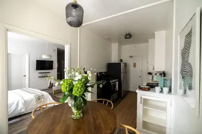 a room with a table with a vase of flowers on it at Cozy Studio in Hollywood in Los Angeles