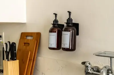 two bottles of soap are hanging on a wall at Cozy Studio in Hollywood in Los Angeles