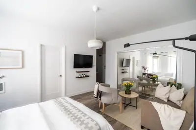 a bedroom with a bed and a living room at Cozy Studio in Hollywood in Los Angeles
