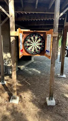 a dart board on a stand in a building at Little Bear Lodge in Springville