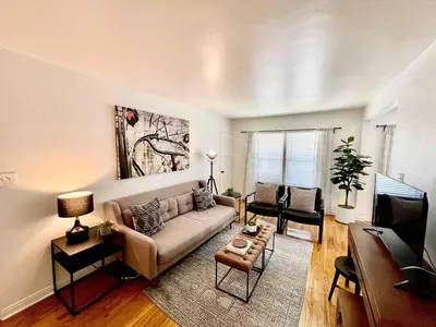 a living room with a couch and a tv at Remodeled Bixby Knolls 2 bedroom unit - Close to shopping in Long Beach