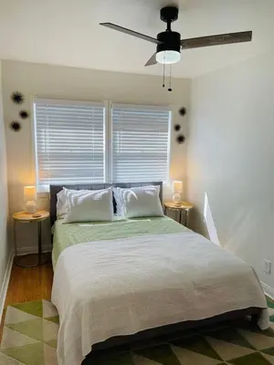 a bedroom with a large bed with two night stands at Remodeled Bixby Knolls 2 bedroom unit - Close to shopping in Long Beach