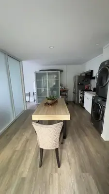 a kitchen with a table and a chair in a room at Joyful Place in Sherman Oaks