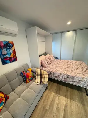 a bedroom with a bed and a couch at Joyful Place in Sherman Oaks
