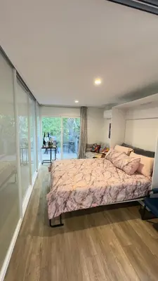 a bedroom with a large bed and a large window at Joyful Place in Sherman Oaks