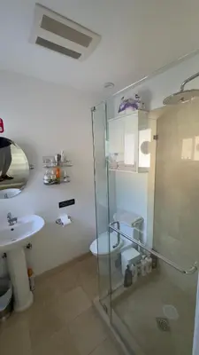 a bathroom with a shower and a toilet and a sink at Joyful Place in Sherman Oaks