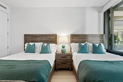 two beds sitting next to each other in a bedroom at Pearl Coast - Modern 2BR with Rooftop Pool & Views in Los Angeles