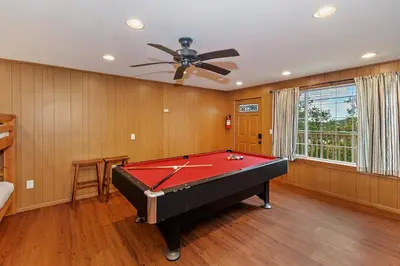 a pool table in a room with a ceiling fan at Emerald Arrowhead Haus - For 6 in Lake Arrowhead