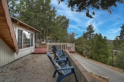 a row of blue benches on the porch of a house at Emerald Arrowhead Haus - For 6 in Lake Arrowhead