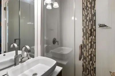 a white bathroom with a sink and a shower at Hollywood Hills Luxury Mansion with Pool & Views in Los Angeles