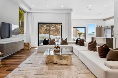 a living room with a white couch and a table at Hollywood Hills Luxury Mansion with Pool & Views in Los Angeles