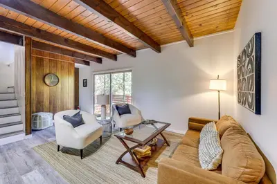 a living room with a couch and two chairs at Deck and Views Modern Cabin Near Lake Arrowhead! in Lake Arrowhead