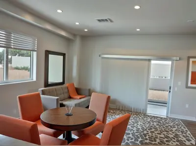 a living room with a table and chairs at Stay in Style Hollywood Residences with Free Parking in Los Angeles
