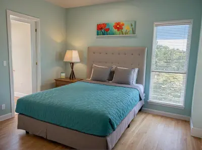 a bedroom with a bed and two windows at Stay in Style Hollywood Residences with Free Parking in Los Angeles