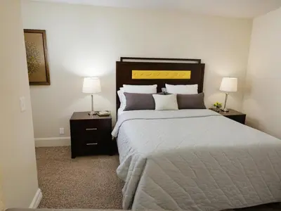 a bedroom with a large bed with two lamps at Stylish Venice Escape Near the Marina & Beachfront in Los Angeles